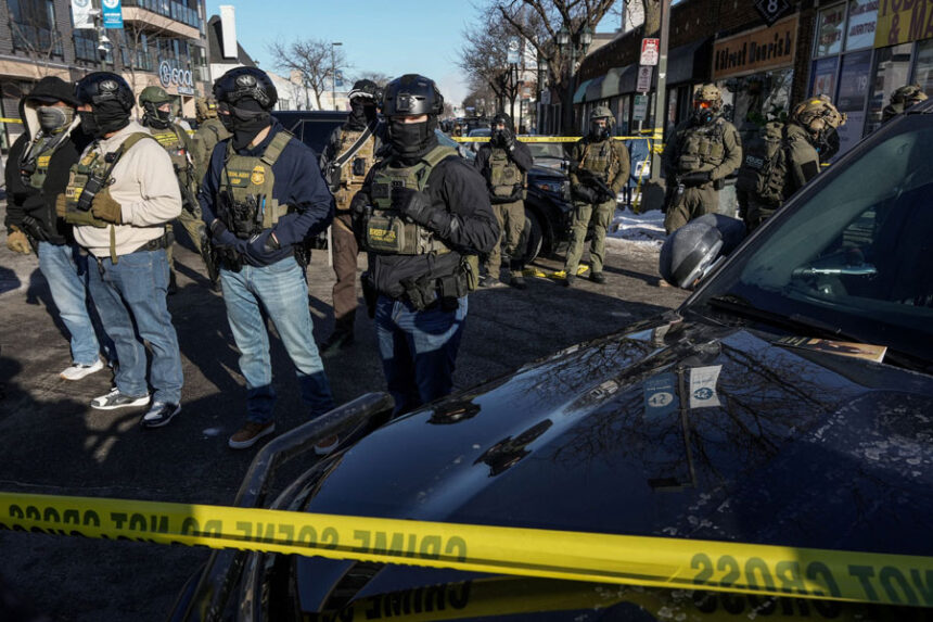 Federal agents stand guard at the scene of a shooting involving immigration agents in Minneapolis, Minnesota, on January 24, 2026.
