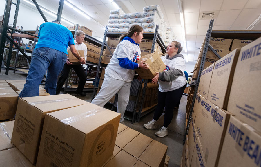 volunteers help unload food truck donation