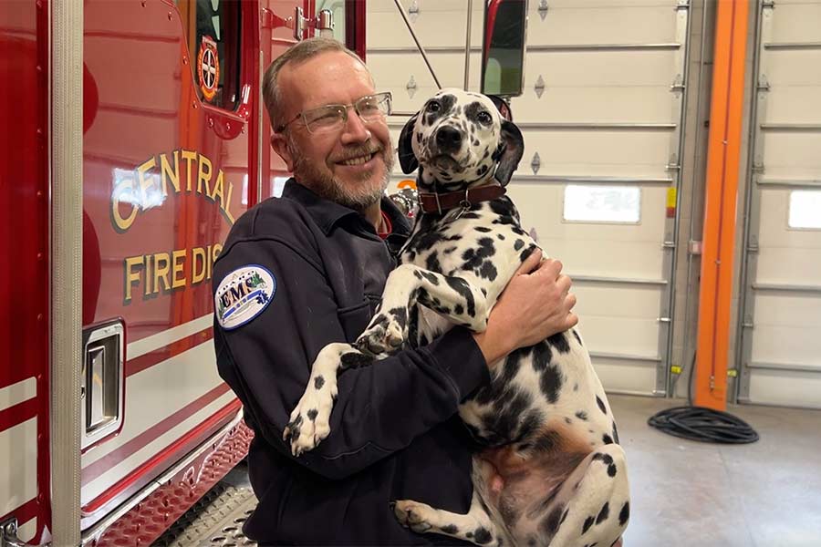 Nathan Bronson with Polka inside the Menan Fire Station | Rett Nelson, EastIdahoNews.com
