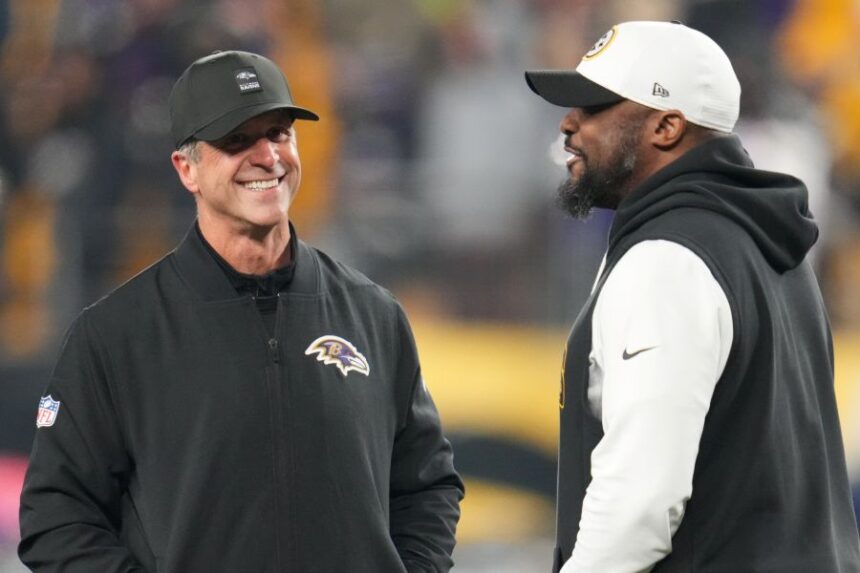 Baltimore Ravens head coach John Harbaugh, left, and Pittsburgh Steelers head coach Mike Tomlin, right, talk before an NFL football game Sunday, Jan. 4, 2026, in Pittsburgh. (AP Photo/Gene J. Puskar)
