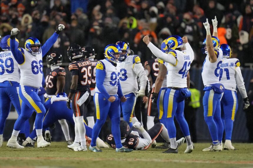 Los Angeles Rams kicker Harrison Mevis, center, reacts with holder Ethan Evans, center right, and teammates after booting a game-winning field goal during overtime of an NFL football divisional playoff game against the Chicago Bears, Sunday, Jan. 18, 2026, in Chicago. (AP Photo/Jeff Roberson)