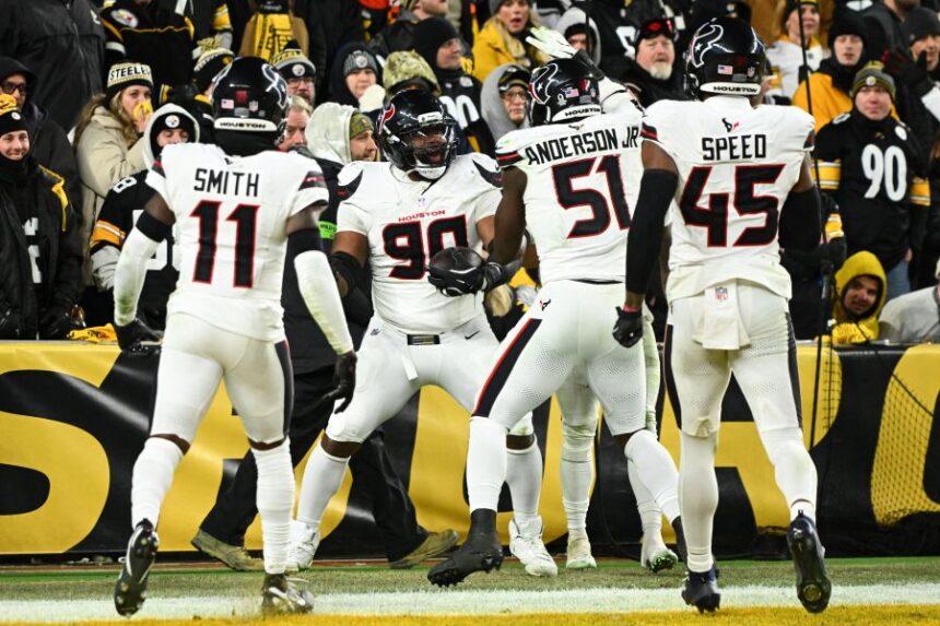 Houston Texans defensive tackle Sheldon Rankins (90) celebrates with cornerback Tremon Smith (11), defensive end Will Anderson Jr. (51) and linebacker E.J. Speed (45) after a touchdown during the second half of an NFL wild-card playoff football game against the Pittsburgh Steelers, Monday, Jan. 12, 2026, in Pittsburgh. (AP Photo/Justin Berl)