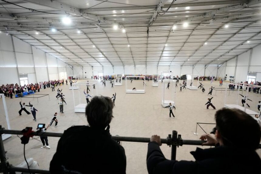Volunteer dancers perform during rehearsals for the opening ceremony of the Milan Cortina 2026 Winter Olympic Games, at a compound in a big tent next to San Siro Stadium, in Milan, Italy, Saturday, Jan. 24, 2026. (AP Photo/Luca Bruno)