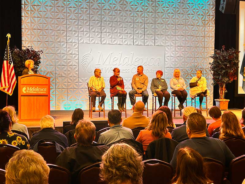 Sharon Eubank at the podium on stage with six representatives of local nonprofits. | Rett Nelson, EastIdahoNews.com
