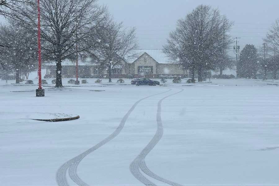 Snow falls outside a shopping center in Columbia, S.C., on Saturday, Jan. 31, 2026.