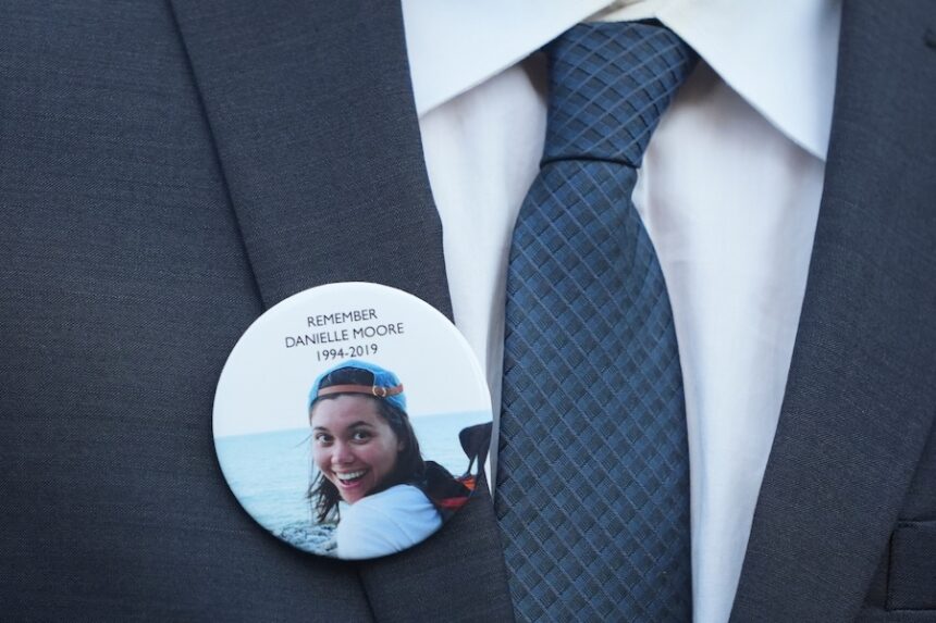 A family member wears a photo of Boeing crash victim Danielle Moore before a hearing at federal court in Fort Worth, Texas, Sept. 3, 2025.