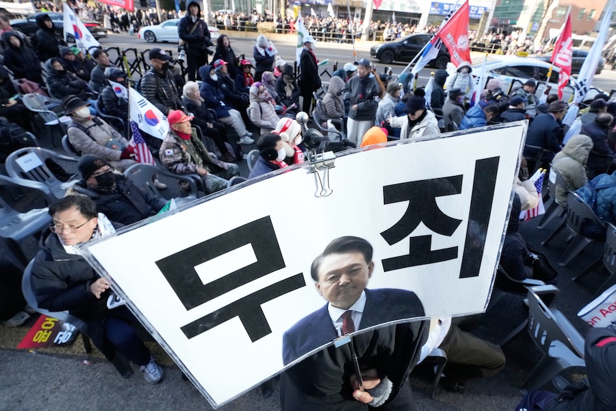Supporters of former South Korean President Yoon Suk Yeol stage a rally outside of Seoul Central District Court in Seoul, South Korea, Thursday, Feb. 19, 2026. A sign reads "Not Guilty."