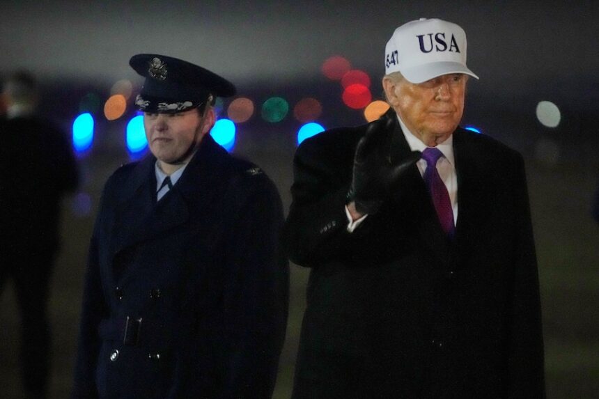 President Donald Trump waves after stepping off Air Force One