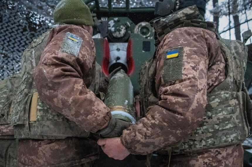 Ukrainian servicemen load an artillery shell before firing at Russian positions on the front line in Kharkiv region of Ukraine