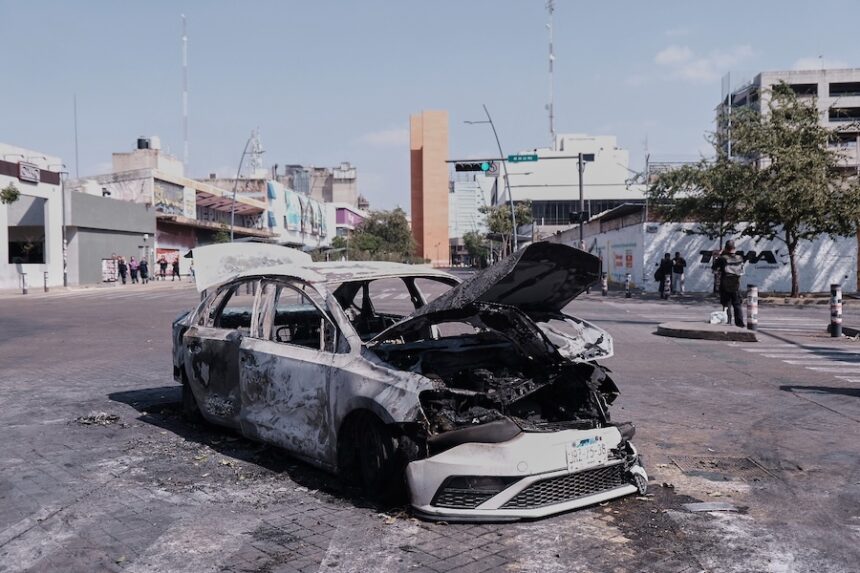 A vehicle sits charred after being set on fire, on a road in Guadalajara, Jalisco state, Mexico, Sunday, Feb. 22, 2026, after the death of the leader of the Jalisco New Generation Cartel, Nemesio Rubén Oseguera Cervantes, known as"El Mencho."