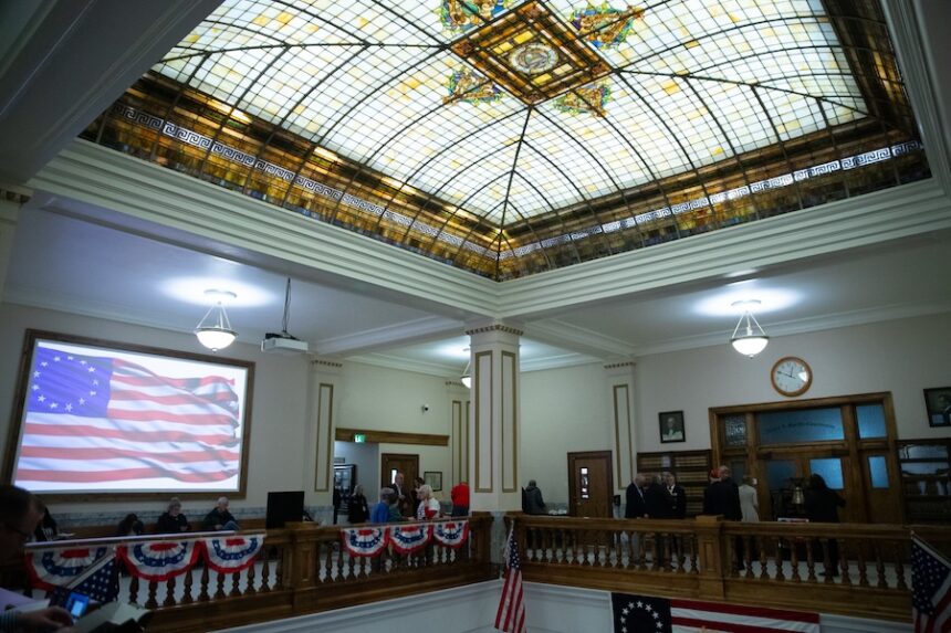 A screen displays the Betsy Ross flag in the Bonneville County Courthouse upper rotunda on Friday, Feb. 13, 2026, during a public reading of the Declaration of Independence.