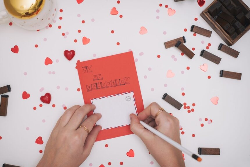 Close up of woman writing Valentine card