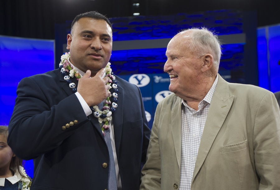 BYU head football coach Kalani Sitake talks briefly with former head coach LaVell Edwards, following a press conference introducing Sitake to the media, in Provo Monday, Dec. 21, 2015.