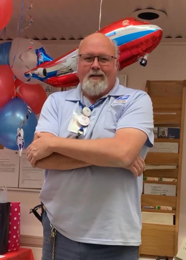 Neal Ard strikes a pose at his retirement party, celebrating a 32 year career with United States Postal Service in Rexburg. Photo courtesy of Tyrone Lewis.