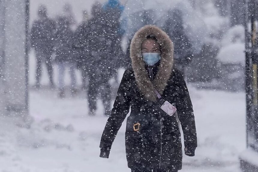 A pedestrian walks along 42nd Street near Bryant Park during a snow storm, Monday, Feb. 23, 2026, in New York. | Seth Wenig, Associated Press