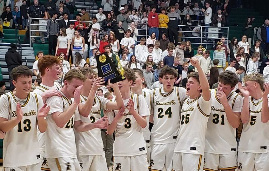 The Bonneville boys basketball team celebrates its district tournament championship on Tuesday. | Allan Steele, EastIdahoSports.com.