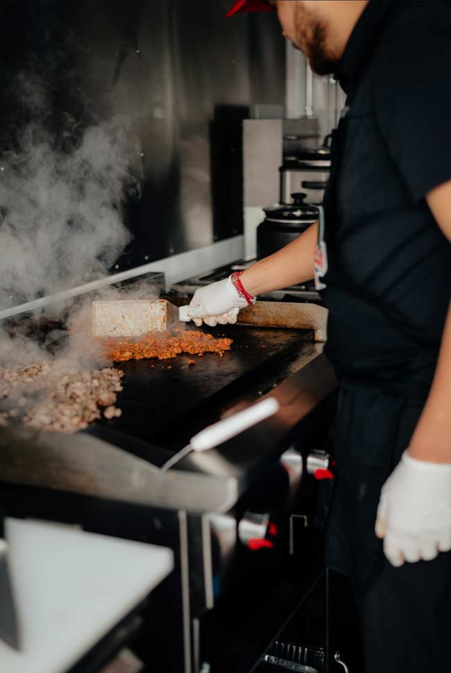 Jose's brother manning the grill at Taqueria El Pollo Loco Jr. | Courtesy Jose Perez