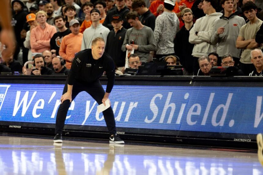 BYU head coach Kevin Young stands on the baseline in the first half of an NCAA college basketball game against Oklahoma State, Wednesday, Feb. 4, 2026 in Stillwater, Okla. (AP Photo/Mitch Alcala)