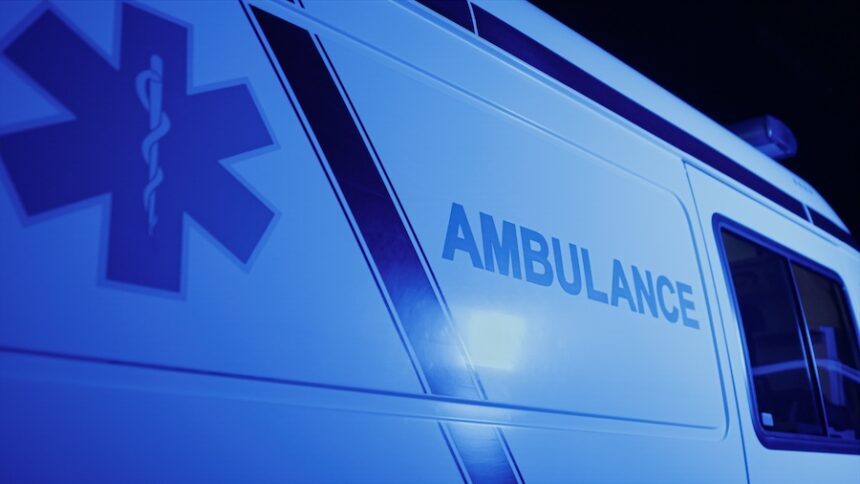 Closeup Emergency Body Of Car With Logo. Detailed View Of Ambulance Vehicle With Emblem. Medical