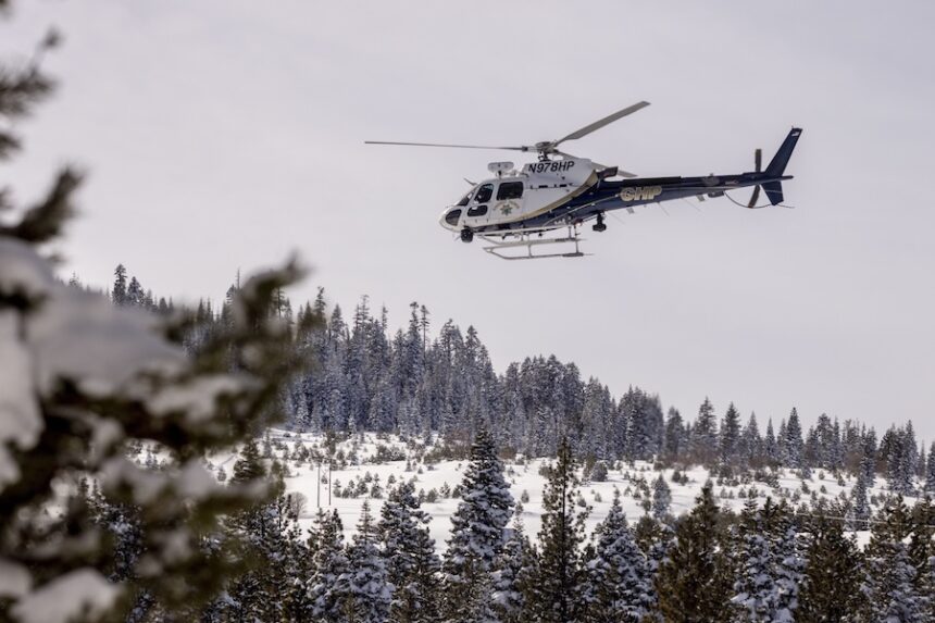 A California Highway Patrol helicopter lifts off from a field after a mission with a search and rescue crew in Truckee, California, on February 20.