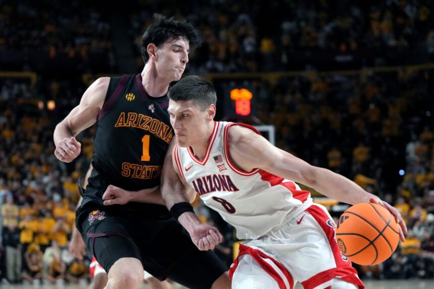 Arizona forward Ivan Kharchenkov (8) drives on Arizona State forward Santiago Trouet during the first half of an NCAA college basketball game, Saturday, Jan. 31, 2026, in Tempe, Ariz. (AP Photo/Rick Scuteri)