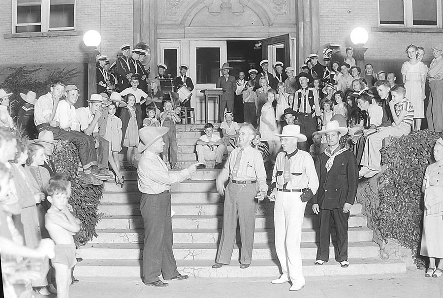 A photo of a group of people taken in front of the Bonneville County Courthouse. The man in the front center is believed to be Mayor/Governor Chase Clark of Idaho Falls, which would make this photo taken around 1937-1938. | Courtesy of Jeffrey Bryant, FSC