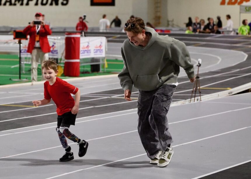 2024 Paralympic gold medalist Hunter Woodhall races a young double-amputee fan Saturday, Feb. 21, 2026, during the 2026 Simplot Games at Idaho State University’s ICCU Dome in Pocatello.