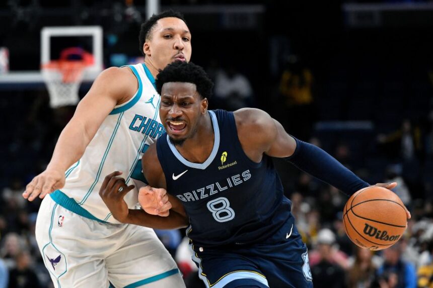 Memphis Grizzlies forward Jaren Jackson Jr. (8) handles the ball against Charlotte Hornets forward Grant Williams (2) in the second half of an NBA basketball game Wednesday, Jan. 28, 2026, in Memphis, Tenn. (AP Photo/Brandon Dill)