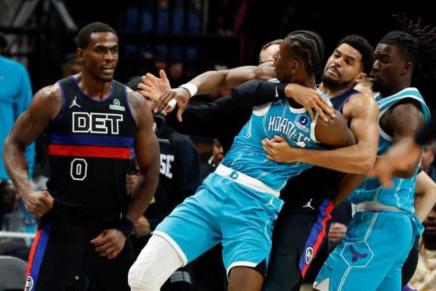 Charlotte Hornets forward Moussa Diabate, front right, is held back as he fights with Detroit Pistons center Jalen Duren (0) fight during the second half of an NBA basketball game in Charlotte, N.C., Monday, Feb. 9, 2026. (AP Photo/Nell Redmond)