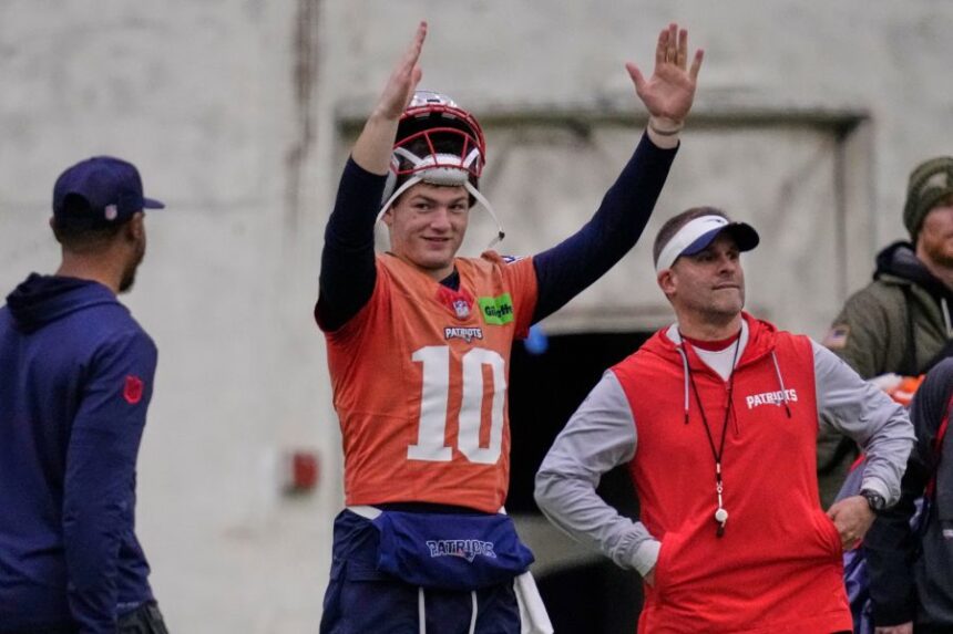 New England Patriots quarterback Drake Maye, left, signals after a field goal while standing with offensive coordinator Josh McDaniels during an NFL football availability, Thursday, Jan. 29, 2026, in Foxborough, Mass. (AP Photo/Charles Krupa)