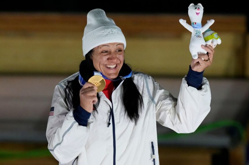 United States' gold medalist Elana Meyers Taylor poses on the podium after the women's monobob competition at the 2026 Winter Olympics, in Cortina d'Ampezzo, Italy, Monday, Feb. 16, 2026. (AP Photo/Aijaz Rahi)