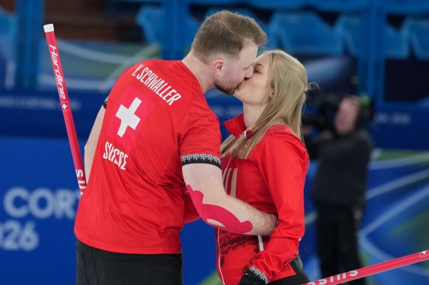 Switzerland's Yannick Schwaller, left, celebrates with Briar Schwaller-Huerlimann, after winning the mixed doubles round robin phase of the curling competition against south Korea at the 2026 Winter Olympics, in Cortina d'Ampezzo, Italy, Thursday, Feb. 5, 2026. (AP Photo/Misper Apawu)