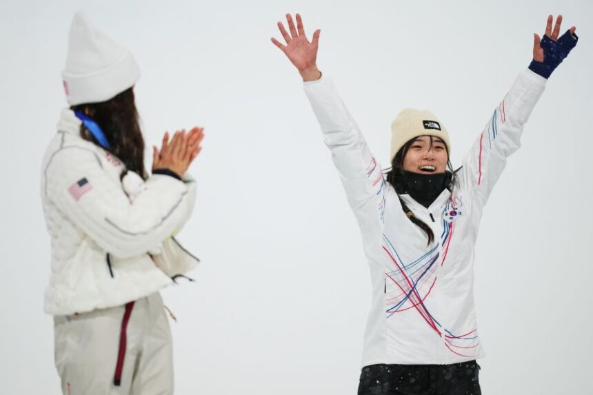 Silver medalist United States' Chloe Kim, left, claps as gold medalist South Korea's Choi Ga-on celebrates winning the the women's snowboarding halfpipe finals at the 2026 Winter Olympics, in Livigno, Italy, Thursday, Feb. 12, 2026. (AP Photo/Abbie Parr)