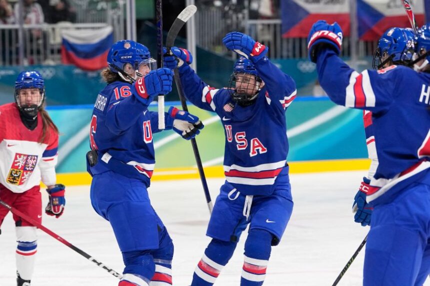 United States' Hayley Scamurra, left, celebrates with teammates after scoring her sides fifth goal during a preliminary round match of women's ice hockey between United States and Czechia at the 2026 Winter Olympics, in Milan, Italy, Thursday, Feb. 5, 2026. (AP Photo/Petr David Josek)