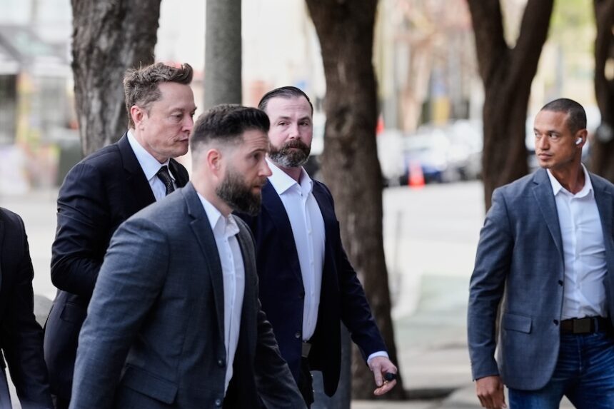 Elon Musk, left, arrives for a Twitter shareholder trial at the U.S. District Court for the Northern District of California, Wednesday, March 4, 2026, in San Francisco.