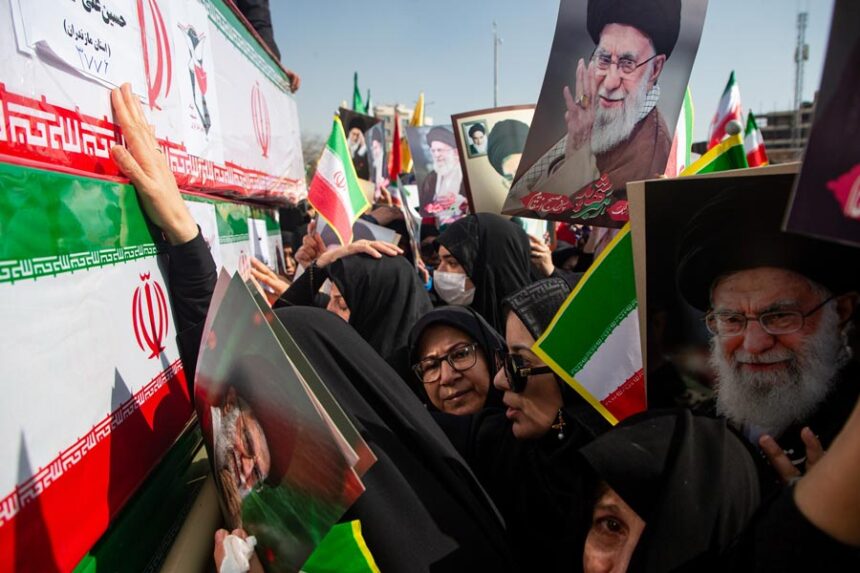 Some holding pictures of the late Iranian Supreme Leader Ayatollah Ali Khamenei, mourners reach out to coffins during a funeral for people killed during the ongoing U.S.–Israeli military campaign in Isfahan, Iran, Thursday, March 5, 2026. | Payman Shahsanaei, ISNA via Associated Press