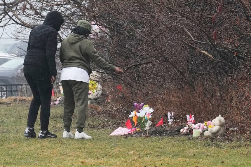 People visit a memorial at the site where two girls bodies were found earlier this week, in Cleveland, Thursday, March 5, 2026.