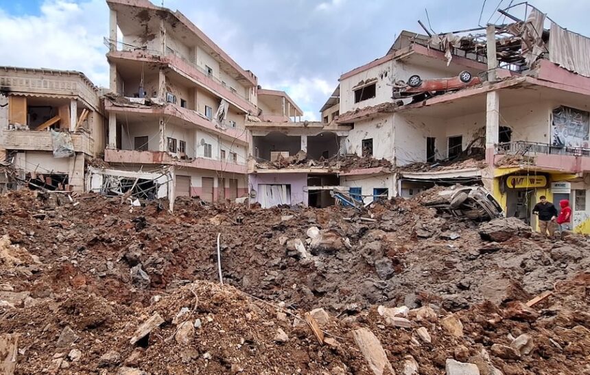 People check the damage left by Israeli airstrikes, Saturday, March 7, 2026, in the village of Nabi Chit, eastern Lebanon late Friday, where Israeli forces landed overnight and dug a grave in a cemetery searching for Israeli co-pilot Ron Arad who was captured and then went missing after his fighter jet crashed over south Lebanon in 1986.