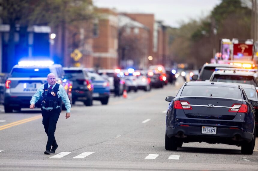 Emergency officials gather outside Old Dominion University's campus after reports of an active shooter on Thursday, March 12, 2026 in Norfolk, Va.