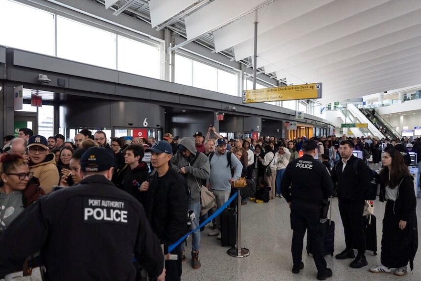 People wait in a TSA line at the John F. Kennedy International Airport, Sunday, March 22, 2026, in New York.