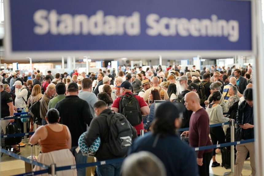 Passengers wait in a security checkpoint line at George Bush Intercontinental Airport, Wednesday, March 25, 2026, in Houston.