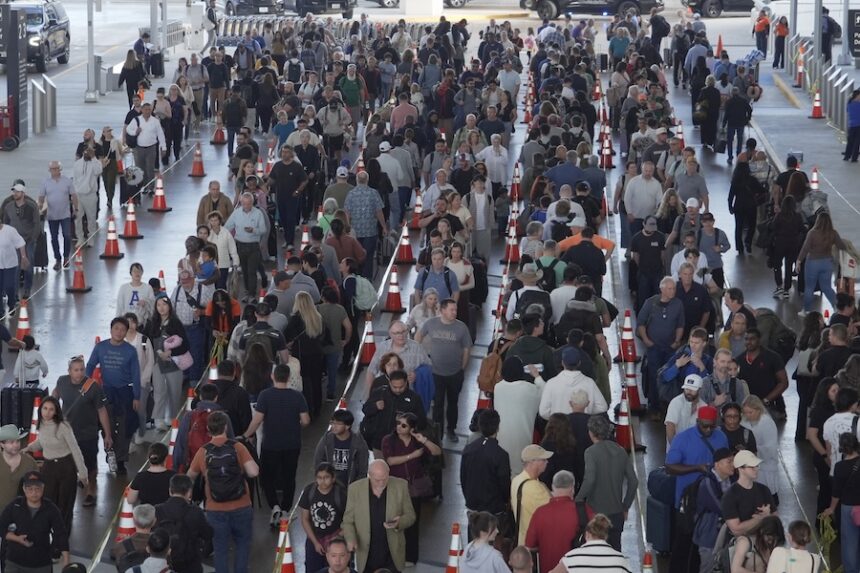 Travelers line up at a TSA checkpoint at George Bush Intercontinental Airport in Houston, Thursday, March 26, 2026.