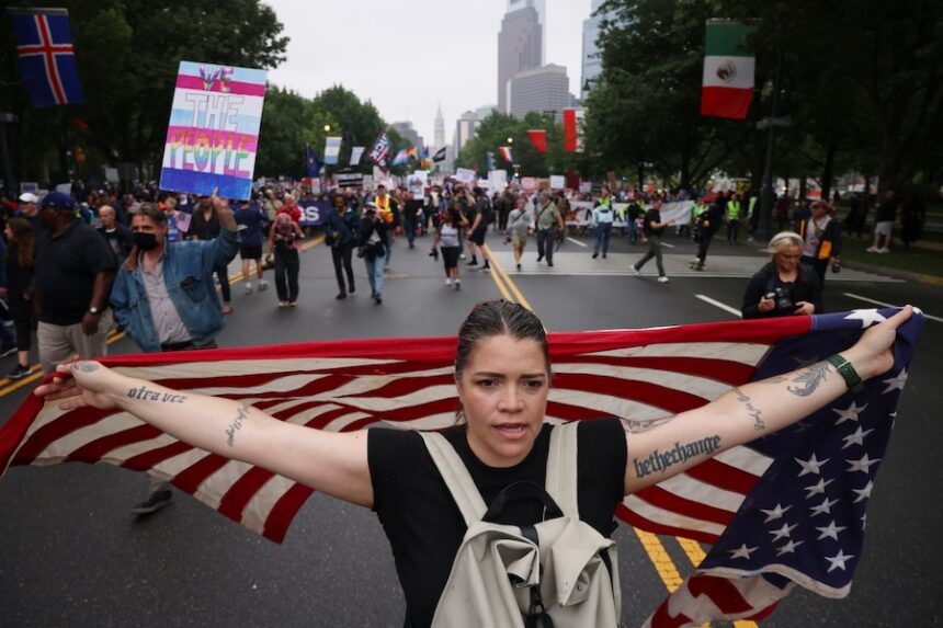 Demonstrators march down Benjamin Franklin Parkway during the "No Kings" protest, June 14, 2025, in Philadelphia.