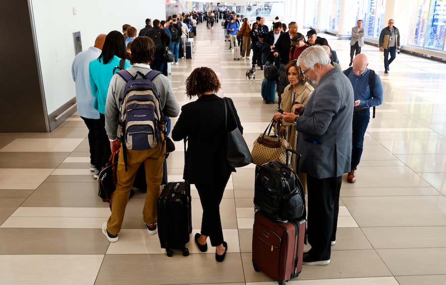 Passengers stand in the TSA pre-check line at LaGuardia Airport, Thursday, March 26, 2026, in New York.