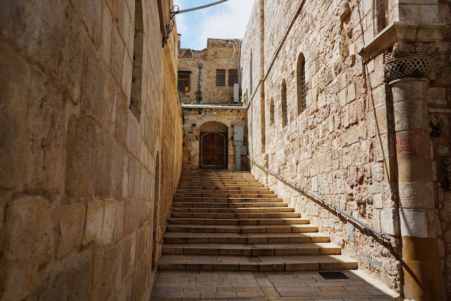 A locked door and empty stairs leading to the Church of the Holy Sepulchre in Jerusalem's Old City, closed to visitors amid heightened security during the war with Iran, Friday, March 27, 2026.