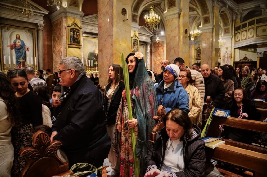 Catholic faithfuls attend a Palm Sunday mass at the Monastery of Saint Saviour in Jerusalem's Old City Sunday, March 29, 2026.