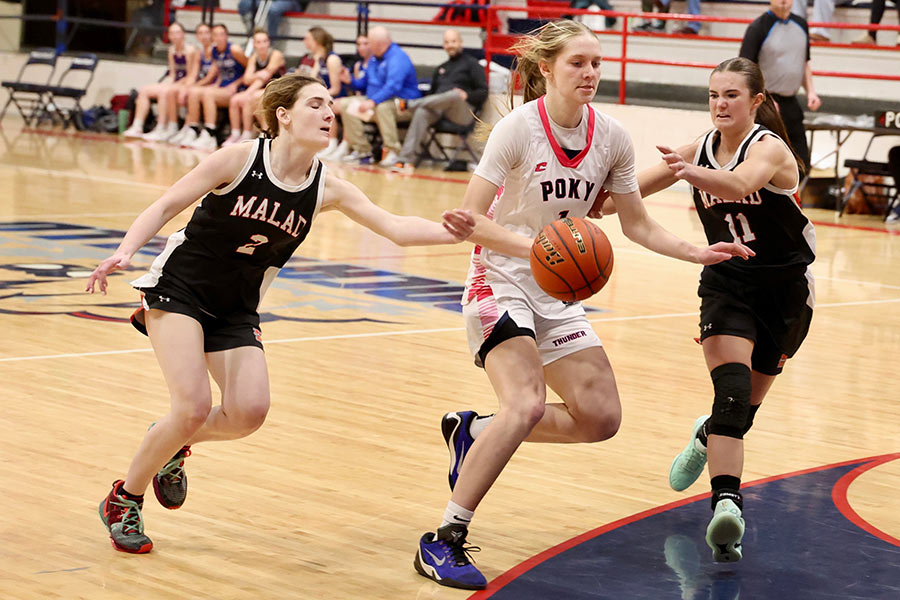 Pocatello Abby Lusk drives against a duo of Malad Dragons