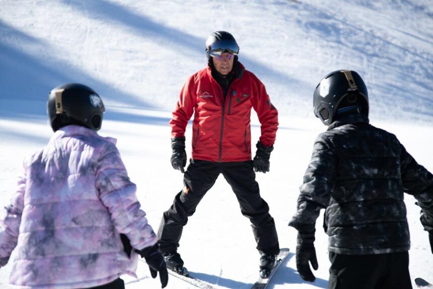 Bob Carlson demonstrates how to make a “pizza” with his skis for Lexi Ward and Greyson Ward at Kelly Canyon on Friday. | Cody Roberts, EastIdahoNews.com