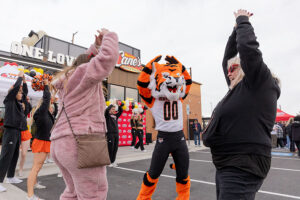 Jenny and Miranda Mortell of Kuna dancing with Benny the Bengal during Raising Cane's opening in Chubbuck. | Daniel V. Ramirez, EastIdahoNews.com