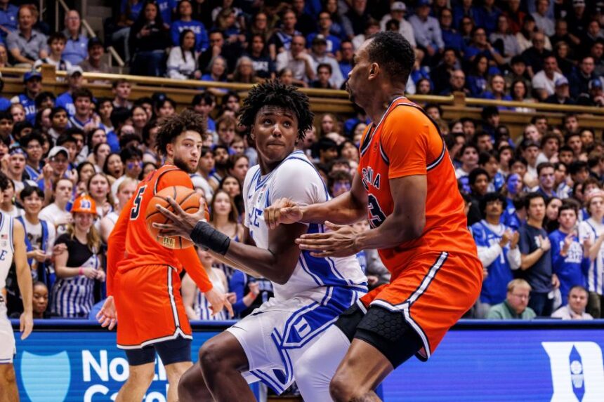Duke's Patrick Ngongba II, left, works in the post against Virginia's Ugonna Onyenso, right, during the second half of an NCAA college basketball game in Durham, N.C., Saturday, Feb. 28, 2026. (AP Photo/Ben McKeown)